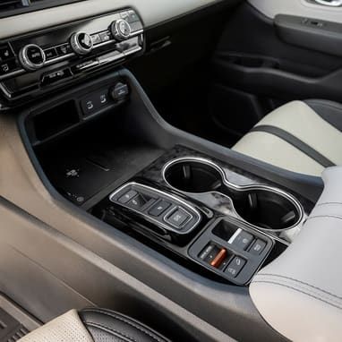 2027 Honda Passport center console featuring a wireless charger and USB ports (Mid-Size SUV).