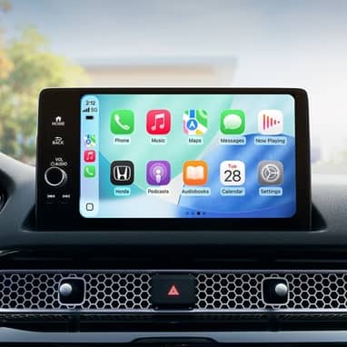 2026 Honda Civic Hatchback Sport Touring Hybrid dashboard with screen displaying Apple CarPlay (Compact Hatchback).
